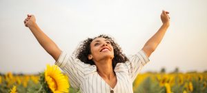 a happy woman in a sunflower field