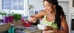 A woman with a bowl of fruits exploring the benefits of integrative nutrition