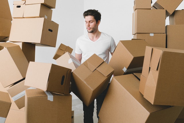 Man surrounded by cardboard boxes