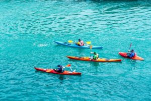 Four people kayaking together.