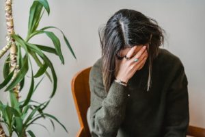 A woman covering her face with her hand
