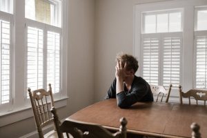 A stressed man sitting at a table