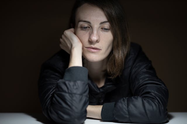A sad woman in a black jacket