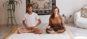 A couple meditating and breathing.