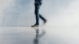 A photo of a person walking captured with motion blur.